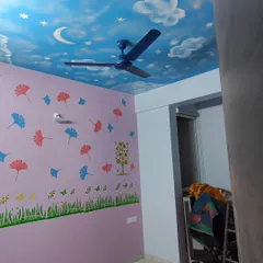 A complete look at a child's bedroom where we combined a sky mural on the ceiling with colorful stencils of trees, grass, and leaves on the walls. This creates a playful and immersive environment for kids.
