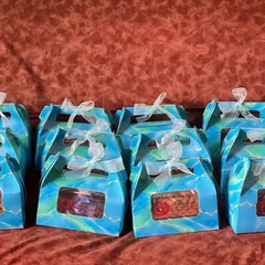 A bulk order of gift boxes for a community event. The vibrant blue boxes with a clear window are perfect for handing out favors and can be customized for weddings or other parties.