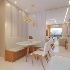 A perfect solution for a compact dining area. This setup includes a custom-built bench with storage, a sleek oval table, and minimalist chairs, creating a cozy and space-efficient dining nook.