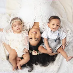 A beautiful overhead portrait of a mother with her boy and girl twins. This pose creates a lovely, symmetrical composition that is full of love.