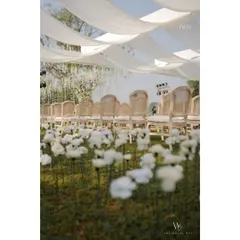 Another view of the whimsical flower field and elegant seating under a draped canopy. The entire setup was designed to feel soft, romantic, and dream-like.