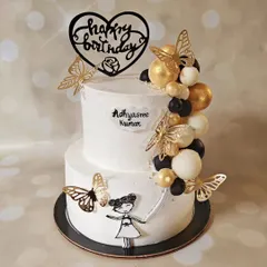 Spread your wings and fly. This beautiful two-tier cake features a cascade of black, white, and gold chocolate spheres, accented with delicate gold butterflies.