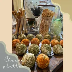 Our assorted cream cheese balls are a party favorite. This platter showcases different coatings like Paprika Garlic and Rosemary Olive, served alongside artisanal crackers and breadsticks for easy dipping.