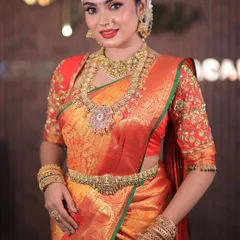 More shots of this gorgeous red and orange Kanchipuram saree. For photoshoots, I ensure every detail, from the pallu to the waist pleats, is absolutely perfect.
