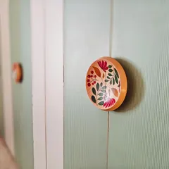 The smallest details tell the biggest stories. These custom wardrobe handles were hand-painted by artisans, turning a functional element into a unique piece of art that adds a personal, floral touch to the bedroom.