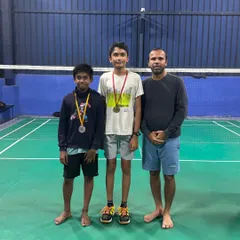 Two of our students proudly display their medals alongside their coach after competing in an academy tournament. We focus on building confidence through healthy competition.