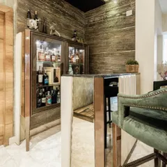 Another view of the bar from image 88, showing the mirrored bar front and glass cabinetry.