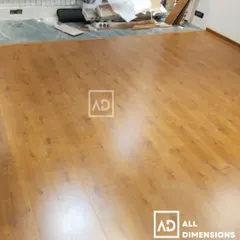 This image captures the installation process, showing the new wooden flooring being laid over the subfloor. My process ensures a perfectly level and durable finish that will last for years.