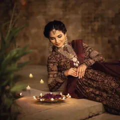 This shot highlights the elegance of the complete look. The makeup is subtle yet defined, ensuring the focus remains on the model's expression and the rich details of her traditional attire, all while maintaining a beautiful, festive glow.