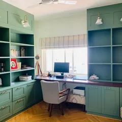 Warning: Productivity levels may skyrocket in this workspace! A beautiful and highly organized home office with custom green cabinetry and ample desk space.