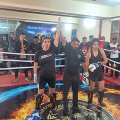 A moment of victory in the ring. One of our female fighters has her hand raised by the referee after winning her bout at the Sanshinkan Open.