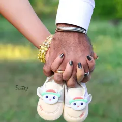 A close-up of a couple's hands holding a tiny pair of baby shoes. This symbolic shot is filled with hope, dreams, and the promise of new adventures to come.