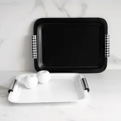 Timeless by design. These black and white trays from the Uma Black Collection, with their classic houndstooth-patterned handles, embody sophistication, minimalism, and quiet luxury.