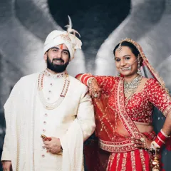 A stylish, posed portrait of the bride and groom with a creative angel-wing background effect. We offer a mix of classic and modern portrait styles.