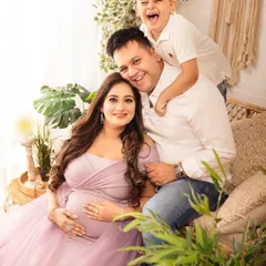 A candid moment of pure family joy. Including older siblings in maternity shoots makes them feel special and captures the excitement of the growing family.