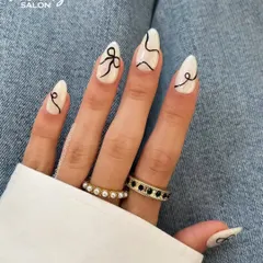 For a modern and chic vibe, I hand-painted these abstract black lines and delicate bows over a clean white base on these almond-shaped extensions. This design shows how minimalist nail art can still be incredibly eye-catching and unique.