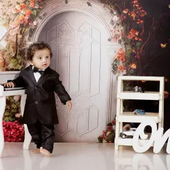 A dapper little gentleman. This portrait of Naksha in a tiny tuxedo by a miniature piano shows another one of our creative studio setups. I love creating these imaginative scenes for pre-birthday photoshoots.