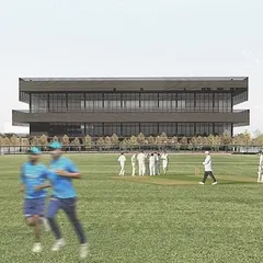 A view of the sports block from the practice grounds. The building's strong horizontal lines and deep cantilevers provide shade and create a dynamic presence, serving as a hub for athletes with facilities for training, recovery, and socializing.