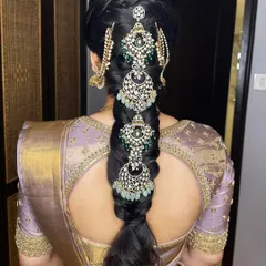 A view of the stunning traditional braided hairstyle, adorned with intricate hair jewelry, perfect for an engagement ceremony.