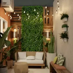 A stylish balcony featuring a large vertical green wall and modern wooden furniture. The string lights add a magical touch, making it an inviting space for day or night.