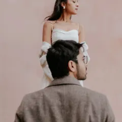 An editorial-style portrait against a simple pink wall in Nice. This image from Brinda and Jeet's pre-wedding shoot on the French Riviera showcases our focus on mood and composition.