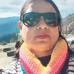 A close-up selfie from a happy customer wearing our rainbow infinity scarf. It looks so warm and cheerful.