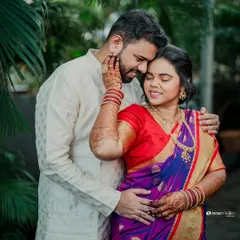 This engagement portrait captures a tender embrace. The groom holds his bride close as she gently touches his face, a gesture full of love and affection.