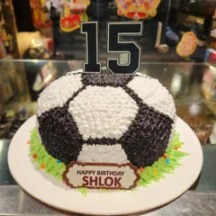 Score a goal with this 3D football cake. Shaped and decorated like a real soccer ball, it sits on a field of green frosting, making it perfect for any football fan's birthday.