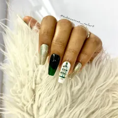 Another festive Christmas design combining gold glitter, dark green, and a white accent nail with a hand-painted Christmas tree. A perfect look for holiday parties.