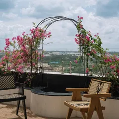 At Eden House, this charming seating nook on the deck is framed by a bougainvillea-lined arch. It’s a picturesque spot that serves as a focal point and a quiet place to enjoy the outdoors.