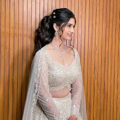 A full view of the Sangeet look, with the voluminous ponytail balancing the embellished lehenga.