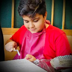 A young artist learning to use a palette knife to create texture. It's a fun, sensory experience that kids absolutely love.
