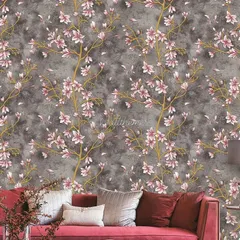 A living room featuring a sophisticated floral wallpaper with pink blossoms on a dark grey textured background.