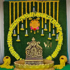 For this Haldi ceremony, we created a traditional yet elegant backdrop. The setup features a lush green wall, a circular arch made of bright yellow marigolds, and a decorative antique-style urn, perfect for this auspicious occasion.
