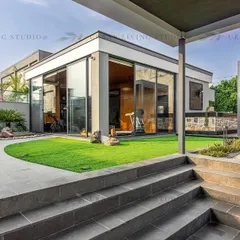 A wide view of our Aligarh project, showcasing how we design complete outdoor ecosystems. This space includes a glass-enclosed gym, a covered lounge area, and manicured lawns, all connected by thoughtfully designed pathways and multi-level structures.