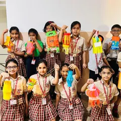 A group of students showcases the beautiful paper lanterns they crafted. These activities encourage creativity, precision, and an appreciation for festive art forms from our Indian heritage.