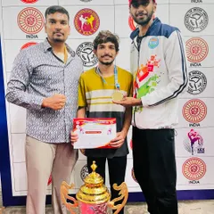 Posing with a gold medalist at the 16th Karnataka State Kickboxing Championship. As a coach, seeing my students succeed is the greatest reward.