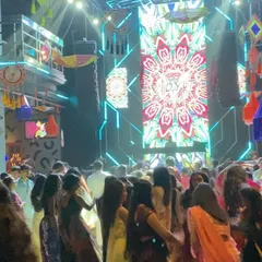 The dance floor is full of people performing Garba, with my custom visuals lighting up the stage. The combination of traditional dance and modern production is what makes these nights special.