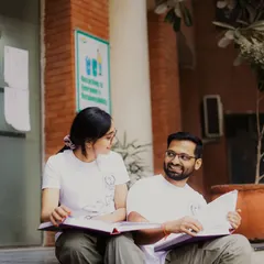 Sharing a moment over textbooks. This photo captures the foundation of their relationship, built on shared goals and late-night study sessions. It's a candid, authentic portrait of their life together.