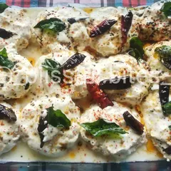 A tray of refreshing Dahi Vada, a popular South Asian snack perfect for cooling down.