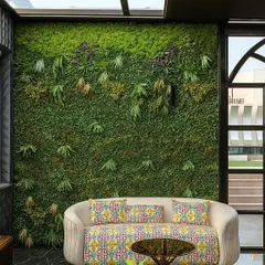 We bring nature indoors with zero maintenance. This artificial green wall serves as a stunning biophilic backdrop in a living area, adding texture, color, and a sense of vitality without the need for water or sunlight.
