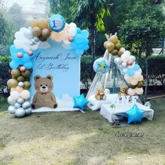 An outdoor teddy bear picnic for a first birthday is such a sweet idea. This setup for Aayansh Jain features a custom backdrop, a teepee cabana for photos, and adorable teddy bears, creating a charming party in the park.