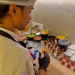 An inside look at the prep station for a gourmet event. My chef is meticulously arranging fish fingers and preparing various dips and sauces.