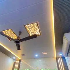 I create modern false ceilings that completely change a room's look. Here you can see a PVC false ceiling with custom geometric cutouts and integrated warm profile lighting, designed to be both stylish and durable. This is a waterproof and termite-proof solution for any home or office.