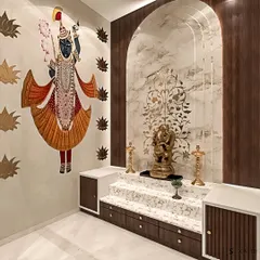 This elegant pooja room features a marble backdrop with delicate inlay work and a grand arch. The wall is adorned with a beautiful Pichwai painting of Shrinathji.