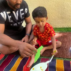 We are all about building bonds, one playdate at a time. A father and son work together on a craft, sharing a quiet moment of focus and creativity.