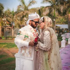 A quiet, intimate moment between the bride and groom amidst the wedding festivities. These are the candid shots that truly capture the essence of their love.