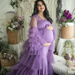 A joyful and radiant solo portrait. The mother-to-be's happy smile and the beautiful tiered lavender gown make this a truly heartwarming shot.