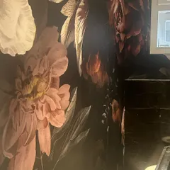 This moody, large-scale floral wallpaper is going up in a powder room. It's going to be a dramatic and beautiful statement.