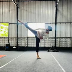 This student demonstrates a high, controlled kick, a testament to his flexibility and strength training.